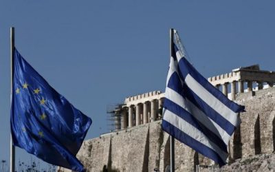 A Greek and an EU flag flutter in front of the temple of the Parthenon during the takeover ceremony of the six-month rotation of Greece's EU Presidency in Athens